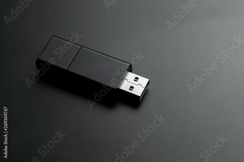 usb memory stick at black matte background. portable storage device.