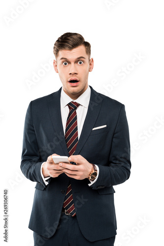 surprised businessman holding smartphone isolated on white
