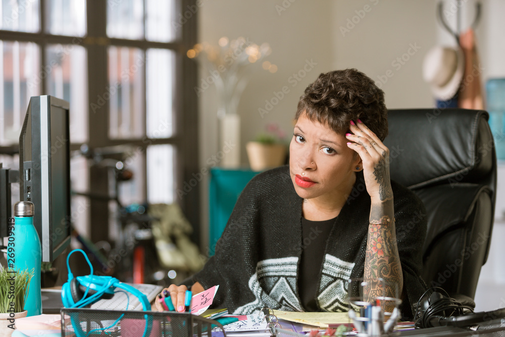 Concerned or Tired  Woman in a Creative Office