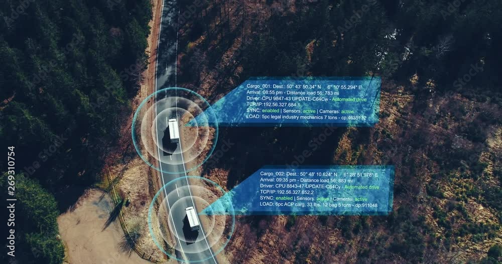 Helicopter shot of self Driving trucks driving on a forest highway with technology assistant tracking information, showing details. Visual effects clip