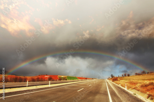 driving on highway under the rainbow