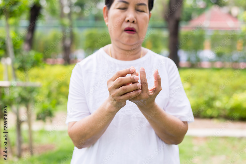 Senior asian woman with beriberi on hand or finger,Disease causing inflammation of the nerves Senior asian woman with beriberi on hand or finger,Disease causing inflammation of the nerves
