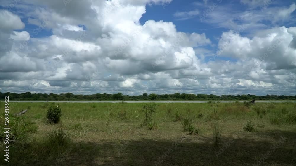A moving time-lapse of the African Landscape in a national park, with lots of moving clouds casting shadows over the ground. A moving time-lapse of the African Landscape in a national park, with lots of moving clouds casting shadows over the ground.