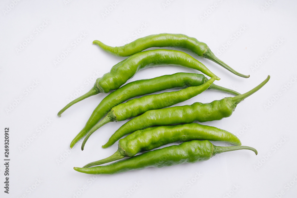 Group of fresh green chili peppers isolated on white background Group of fresh green chili peppers isolated on white background