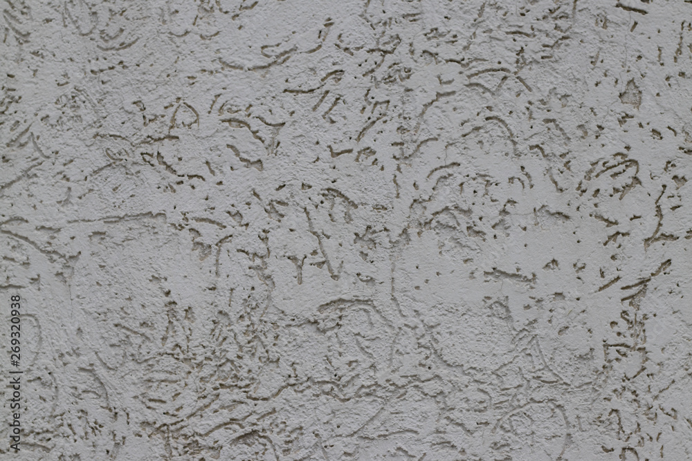 gray, decorative, facade plaster. Close view, interesting ornament, texture. Protective coating, facade protection, construction, construction and finishing works.