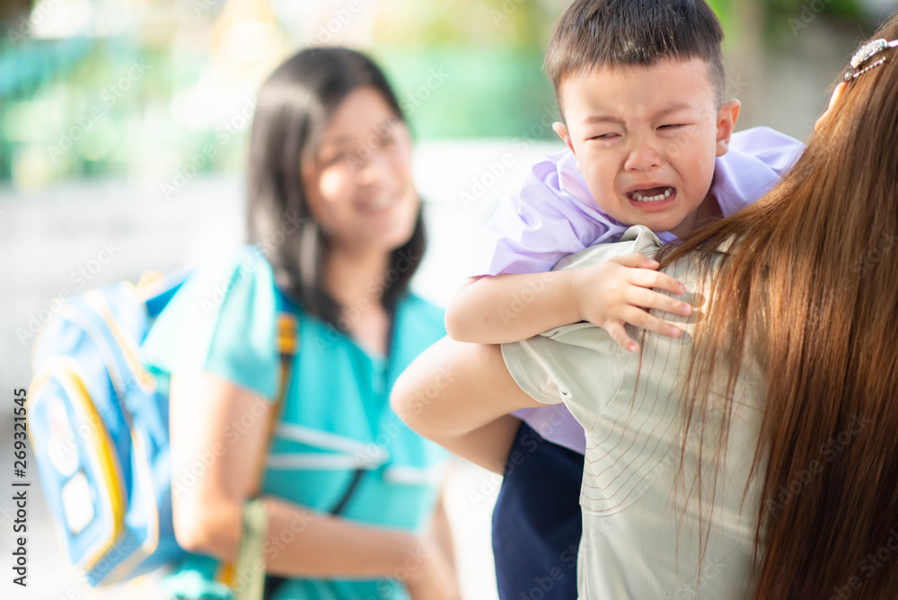 Little toddler boy cry, first day at school kindergarten with mother Little toddler boy cry, first day at school kindergarten with mother