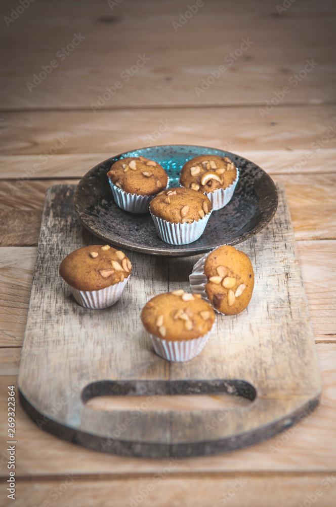 Small cake made from banana milk powder on wooden floor. Small cake made from banana milk powder on wooden floor.