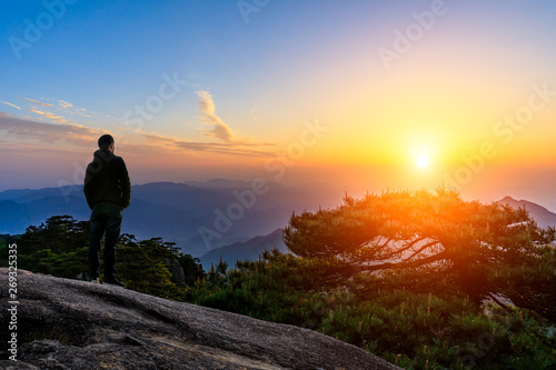 Man on top of mountain conceptual scene