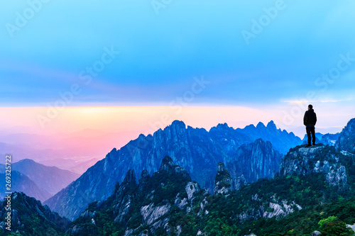 Man on top of mountain conceptual scene