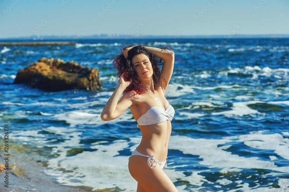 Young woman in a swimsuit on the beach