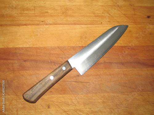 kitchen knife with wooden handle on cutting Board