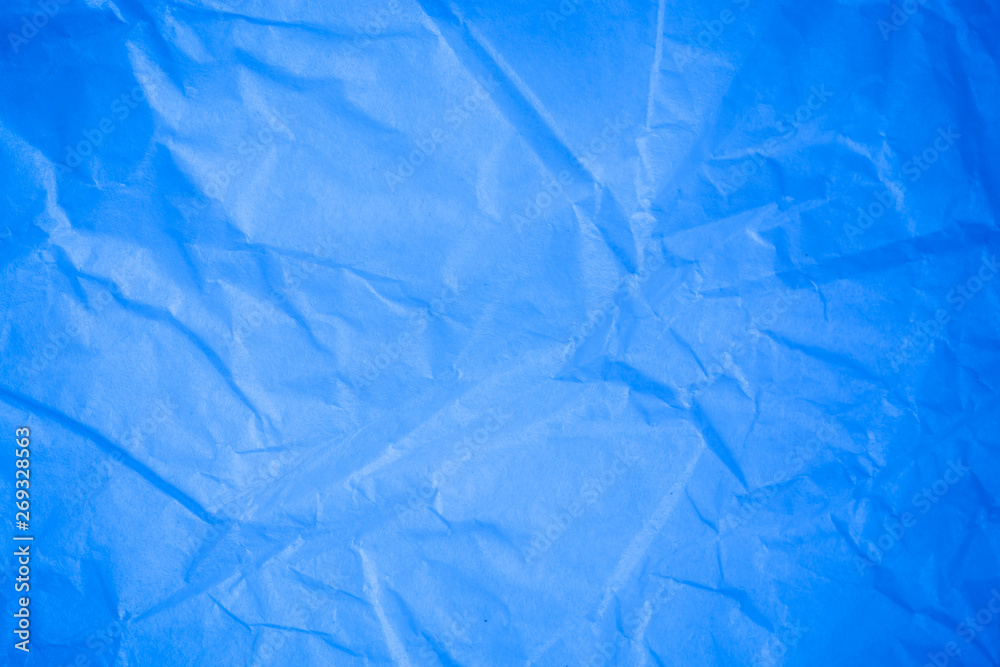 Obraz premium Crumpled blue paper background.