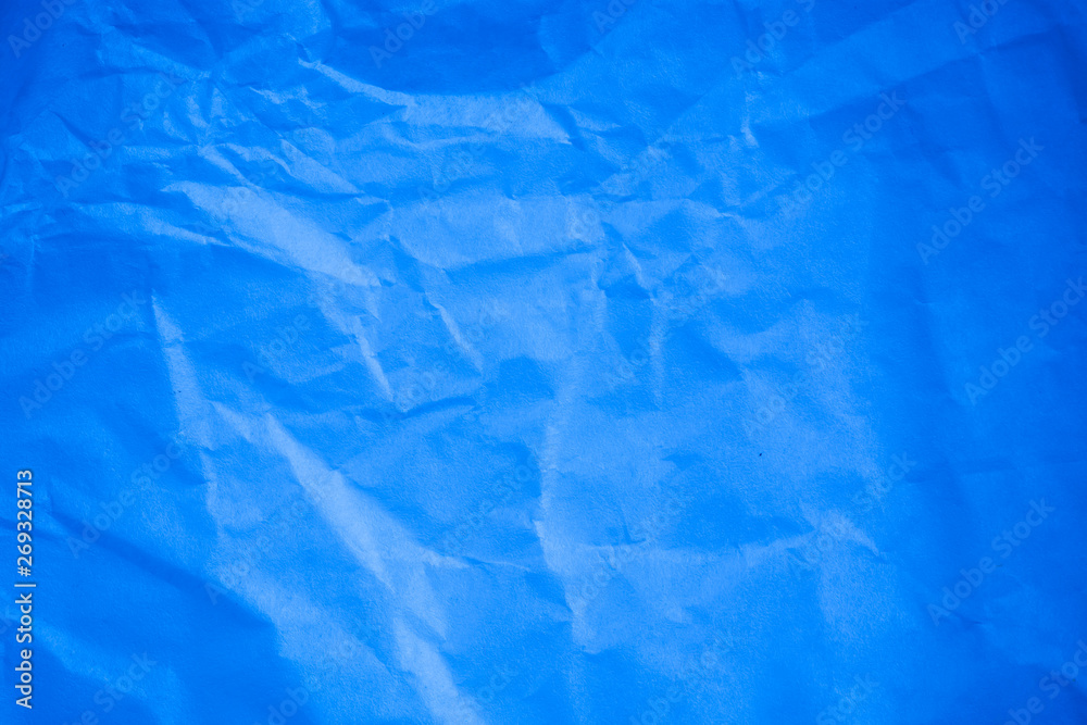 Fototapeta premium Crumpled blue paper background.