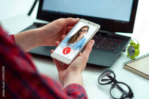 Woman chatting online with friends and family through a video calls. Communication by phone