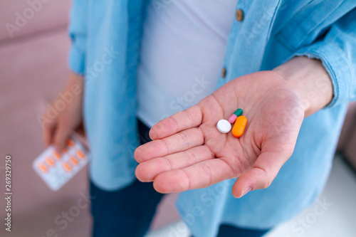 Vitamins and tablets for well-being and disease treatment. Taking pills
