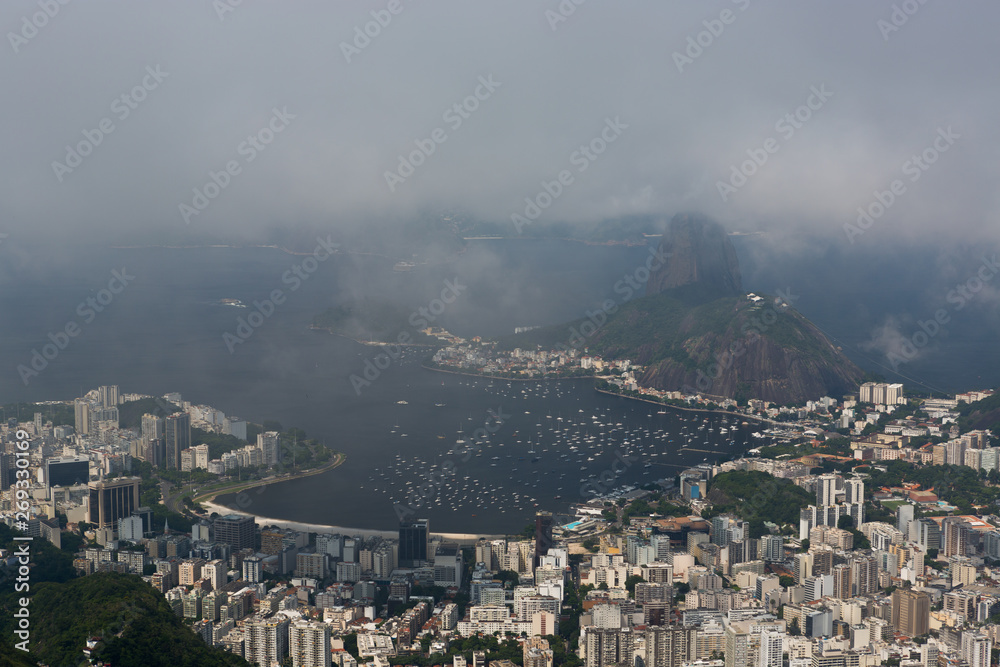 Sugarloaf Mountain (Pão de Açúcar) rising 396 m above the harbor at the mouth of Guanabara Bay on a peninsula and its cableway with panoramic views of the city, Rio de Janeiro, Brazil.