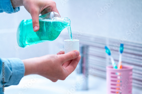 Oral hygiene, use of mouthwash for the health of teeth and gums. Fresh breath. Teeth care. Treatment of dental problems photo