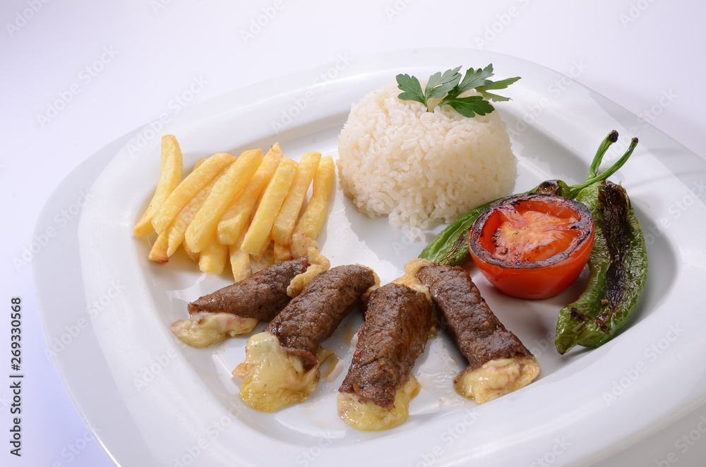 rolled beef steaks filled with cheese with salad and french fries rolled beef steaks filled with cheese with salad and french fries