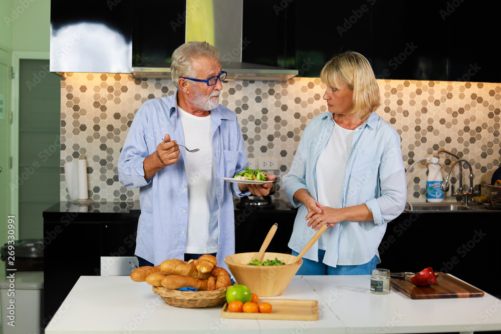 Senior couple Man and woman cooking in kitchen happy mood Senior couple Man and woman cooking in kitchen happy mood