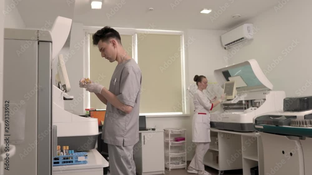 Researchers working in a lab. Scientists using modern laboratory equipment. Professional laboratory medical equipment. Healthcare concept. Approaching camera shot Researchers working in a lab. Scientists using modern laboratory equipment. Professional laboratory medical equipment. Healthcare concept. Approaching camera shot