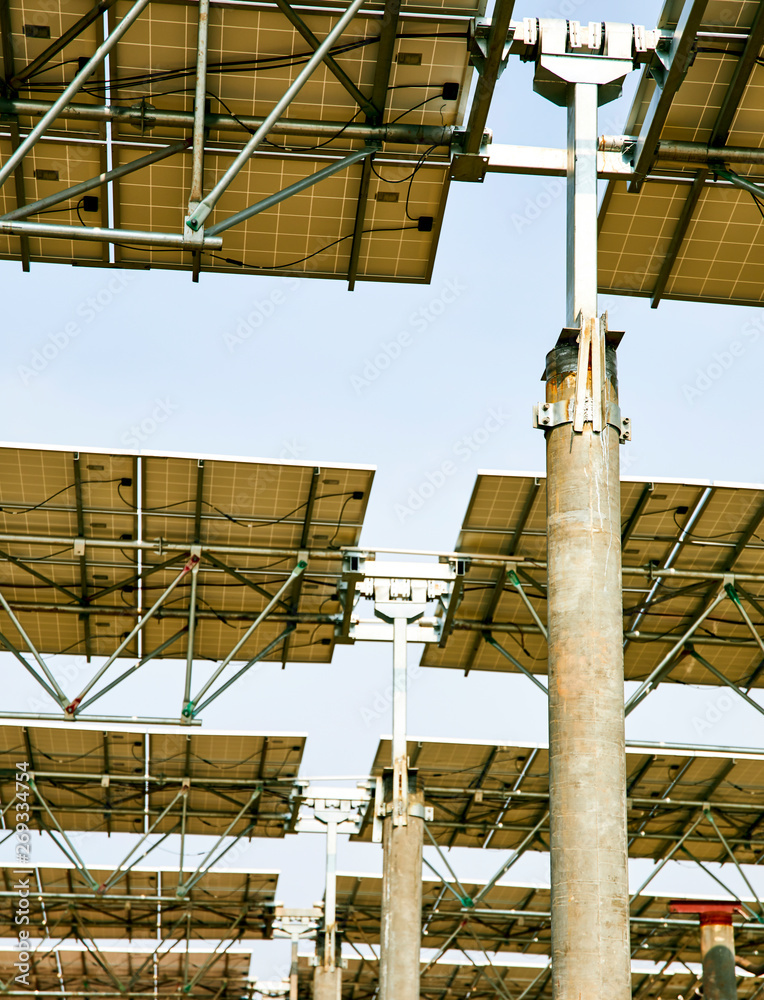 Naklejka premium Looking up at the bottom of the solar photovoltaic panel with automatic rotating bearings
