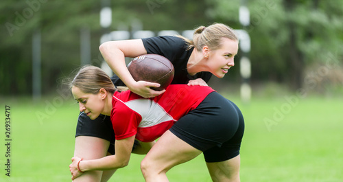 The young female rugby player on green backround