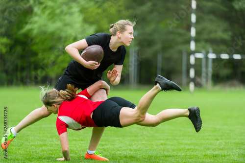 Fotografie The young female rugby player on green backround