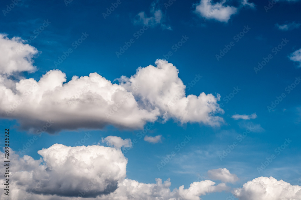 fluffy white cloud on air clear blue sky weather background. high contrast
