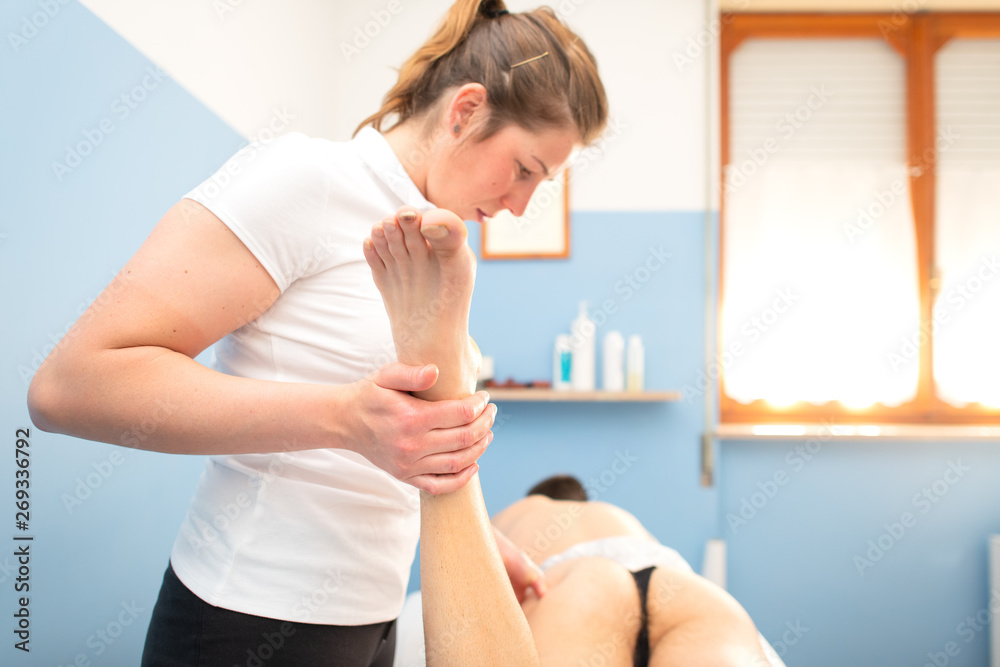 Physiotherapist performs discharge of the piriformis on a sciatic Physiotherapist performs discharge of the piriformis on a sciatic