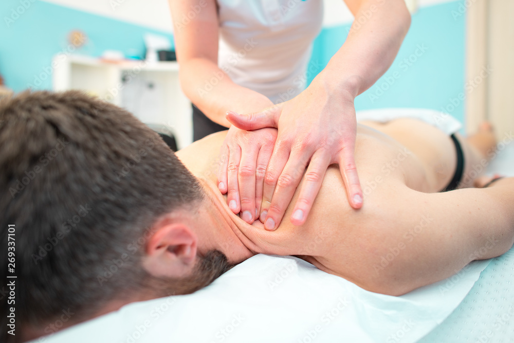 Fototapeta premium Sports treatment for a sporty man in a physiotherapist studio