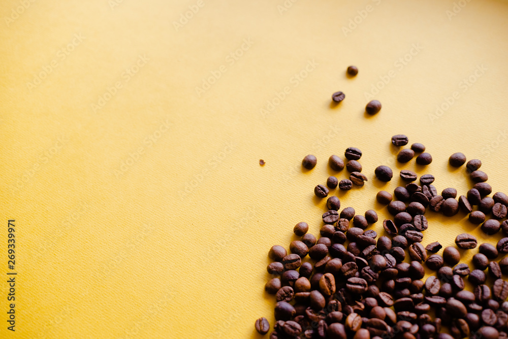 Roasted coffee grains and takeaway cup top view. Craft paper tea cup on orange background flat lay. Cafe web banner with copyspace Roasted coffee grains and takeaway cup top view. Craft paper tea cup on orange background flat lay. Cafe web banner with copyspace