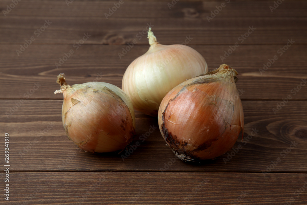 Fototapeta premium 木のテーブルにのせた生のタマネギ