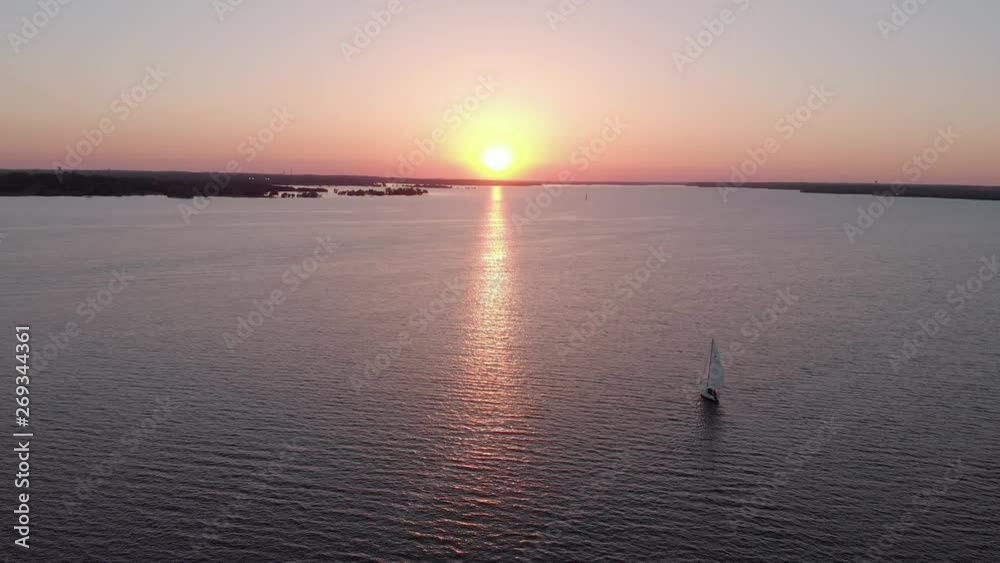 Drone flies over a lake with sailboats Drone flies over a lake with sailboats