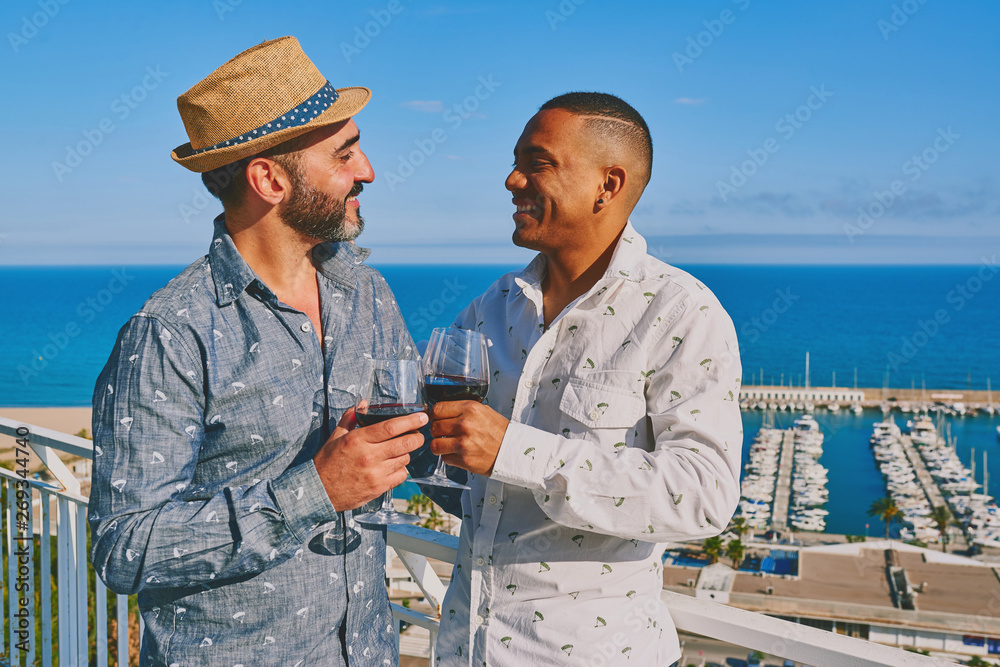 a gay couple with a glass of wine