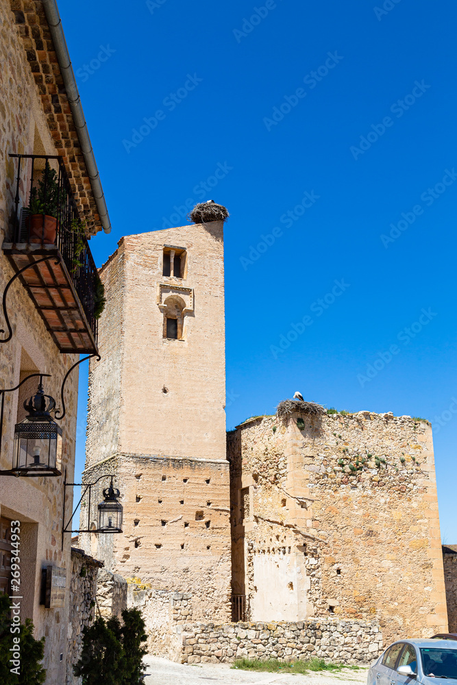 Pedraza, Castilla Y Leon, Spain: ruins of Iglesia de Santa Maria with giant bird's nests on top. Pedraza is one of the best preserved medieval villages of Spain, not far from Segovia