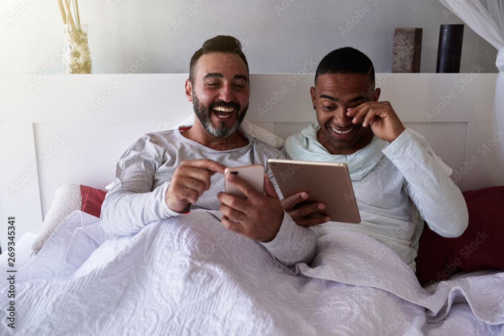 an interracial gay couple in bed Stock Photo | Adobe Stock