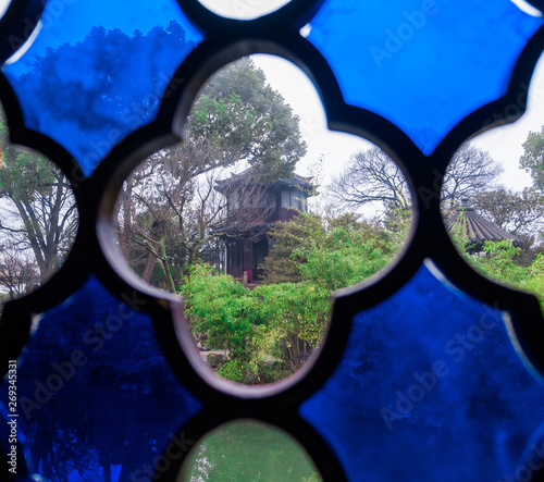 China, Suzhou, Humble Government Park view outside from pavilion through decorative glass