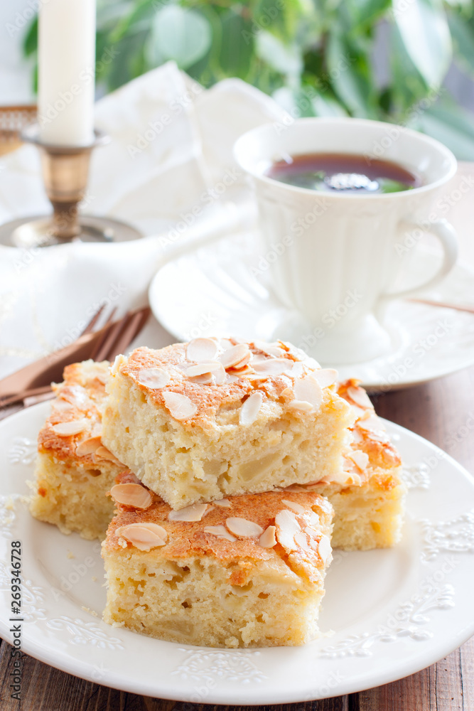 Homemade Apple Pie with Almond Petals on White Crockery, selective focus Homemade Apple Pie with Almond Petals on White Crockery, selective focus