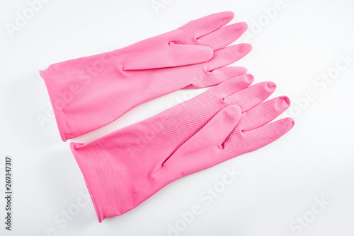 Pair of pink rubber gloves on white background