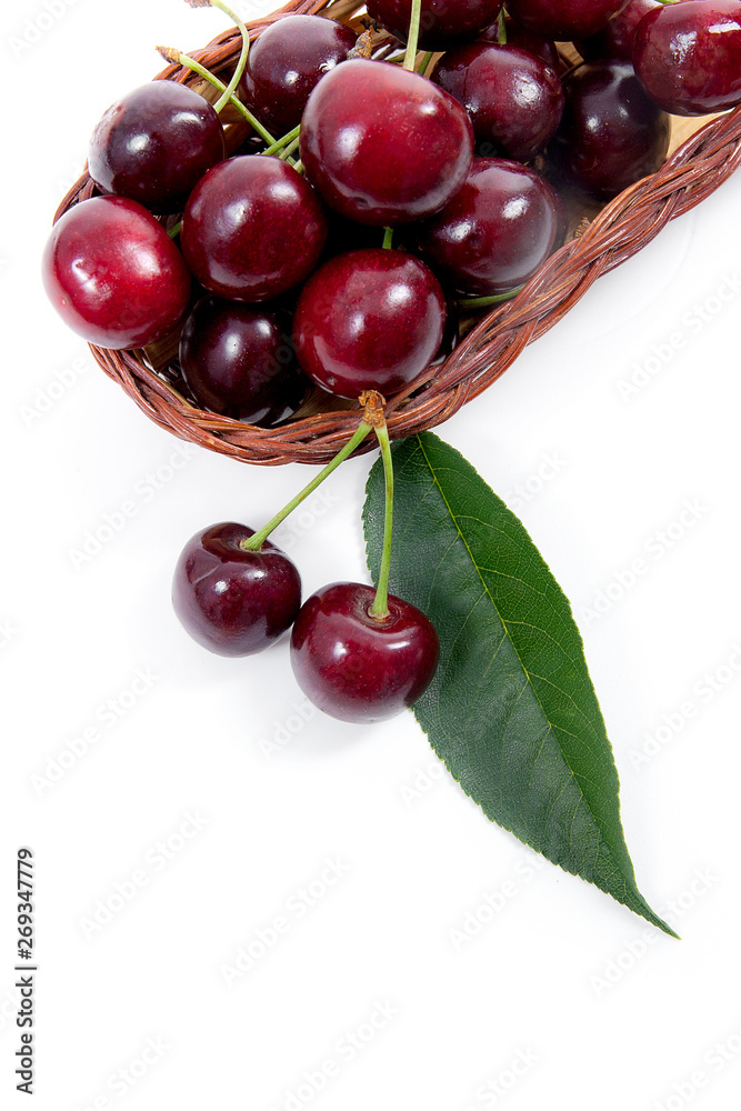 Yellow wooden basket with red sweet cherry isolated on a white background.. Yellow wooden basket with red sweet cherry isolated on a white background..