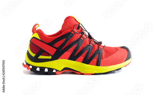 Side view of red trail running shoe or trekking boot isolated on white background