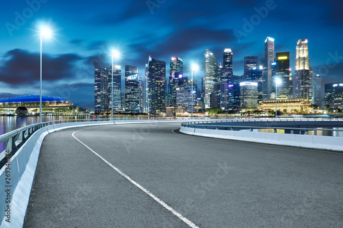 Canvas Print High speed corner overpass asphalt road with Singapore cityscape , night scene