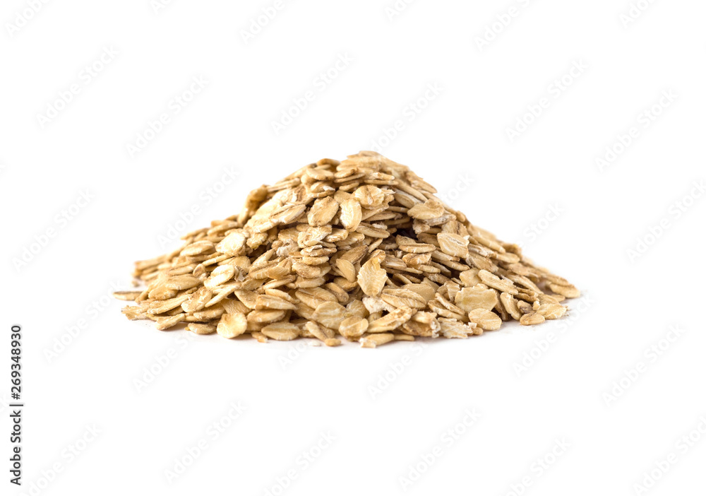 Obraz premium Side view of uncooked oat flakes pile. Oatmeal isolated on white
