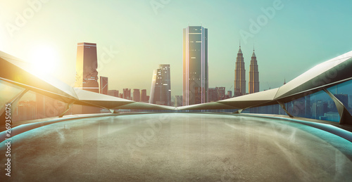 Panoramic view of futuristic geometric shapes design empty floor with Kuala Lumpur city skyline . Sunrise scene . © jamesteohart