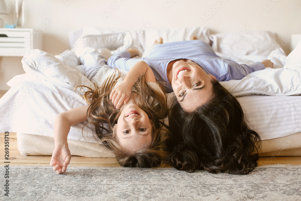 Happy mother with daughter resting at home
