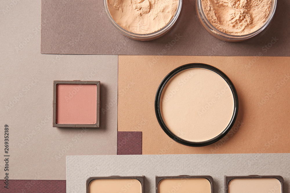 Fototapeta premium Different facial powder on color background