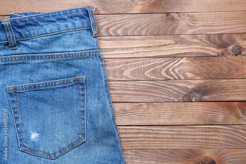 Stylish jeans shorts on wooden table