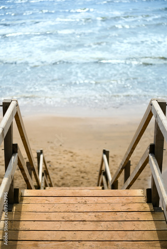 Wooden stairs leading to sandy beach and the sea © Gareth