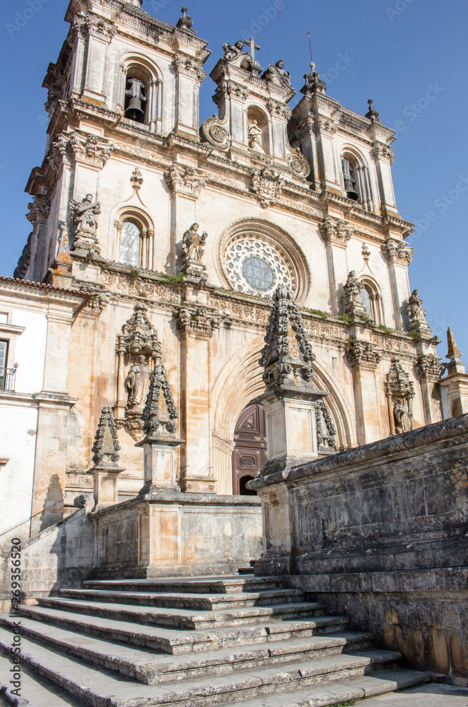 Exterior front of the Alcobaca Monastery, or Mosteiro de Santa Maria de Alcobaca, in Portugal. No people.