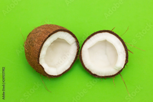 Broken coconut on a green background